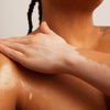 Model Applying Body Oil